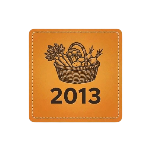 Orange square patch with stitched border. Features an illustration of a woven basket filled with fresh vegetables and the text "2013."