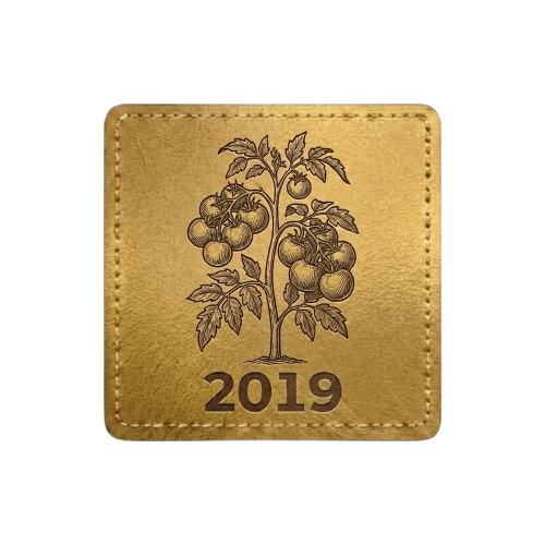 Tan square patch with stitched border. Features a silhouette of a tomato plant with the text "2019."