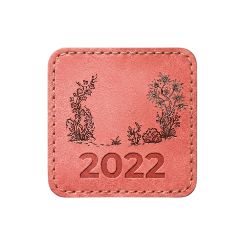 Coral-colored square patch with stitched border. Features a detailed illustration of two rabbits amidst sprawling vines and floral elements.