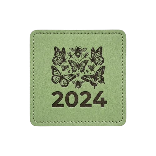 Sage green square patch with stitched border. Features a silhouette of various butterflies and the text "2024."
